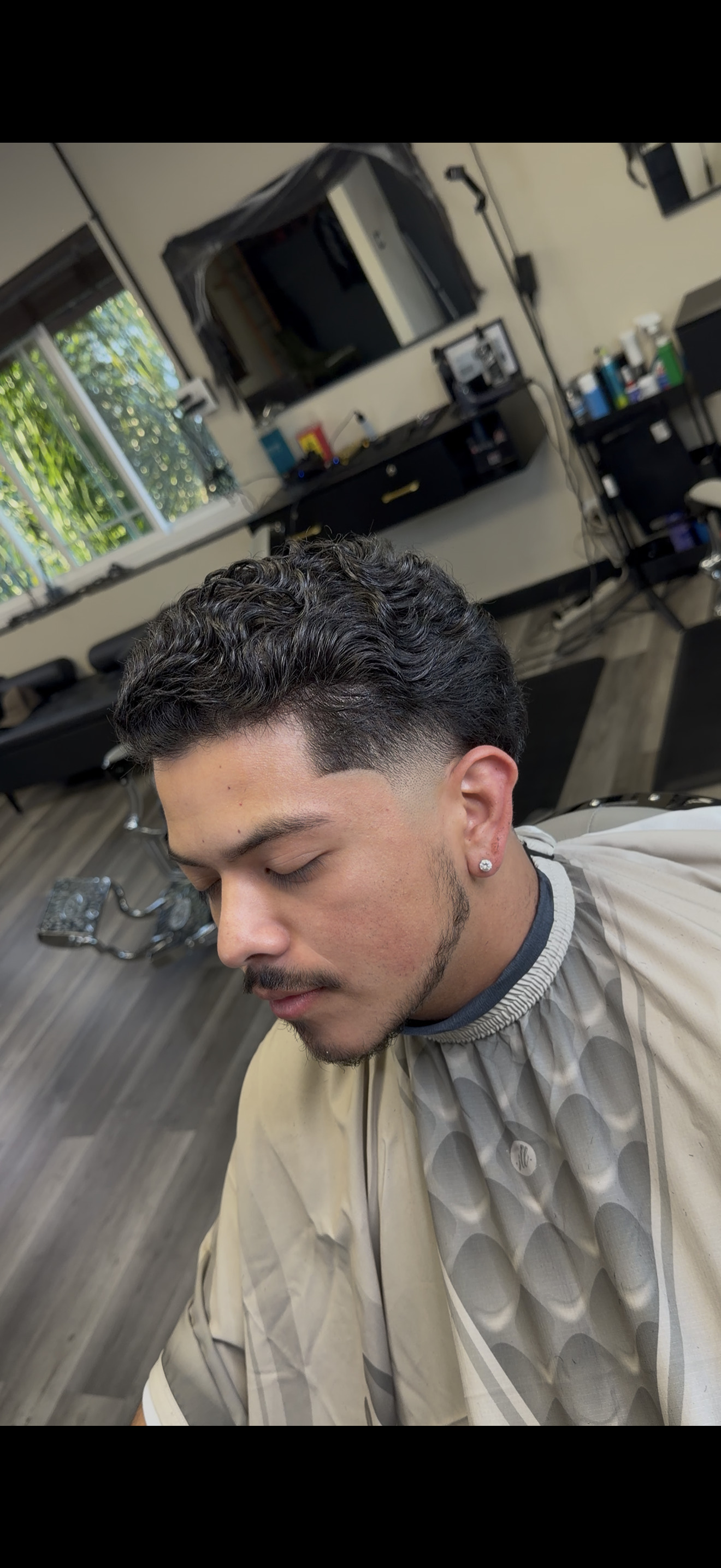 Curly top taper fade at Sharp Society Barbershop Richmond CA