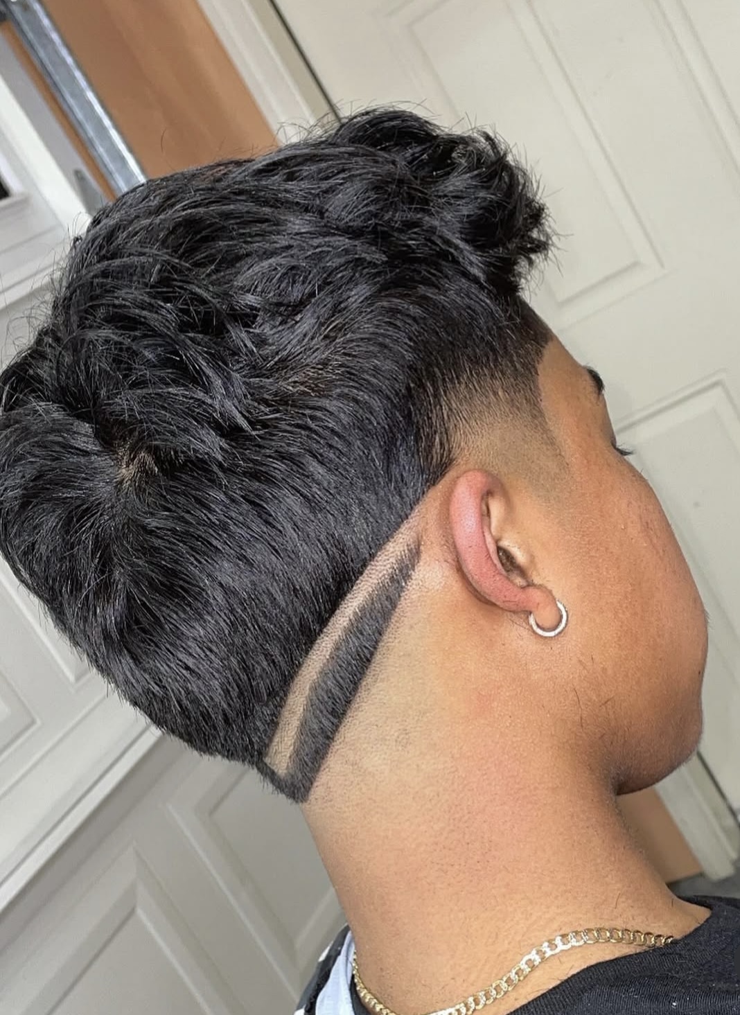 Textured top with tapered fade and line design by Sharp Society Barbershop