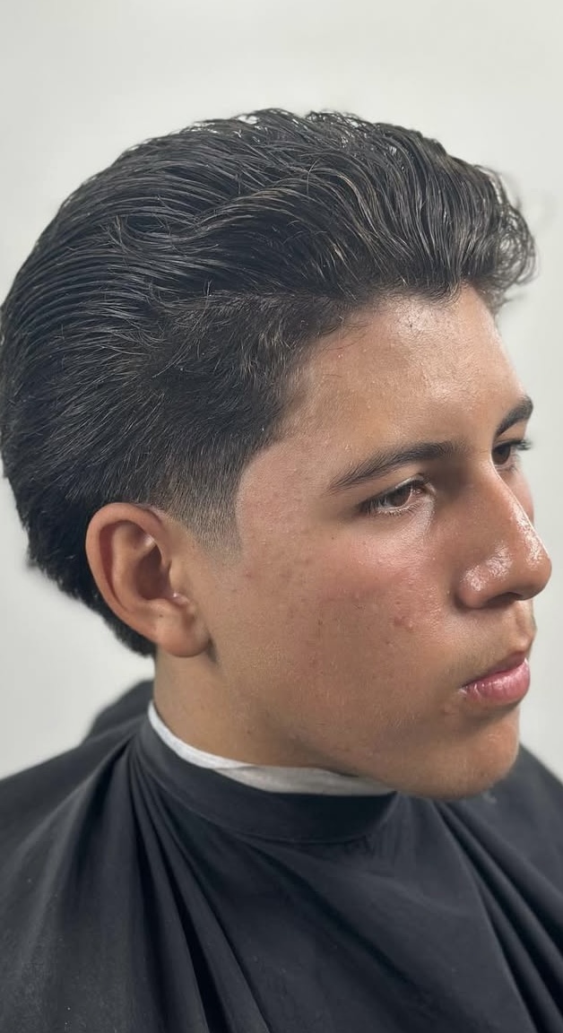 Classic slicked back pompadour with taper by Sharp Society Barbershop Richmond