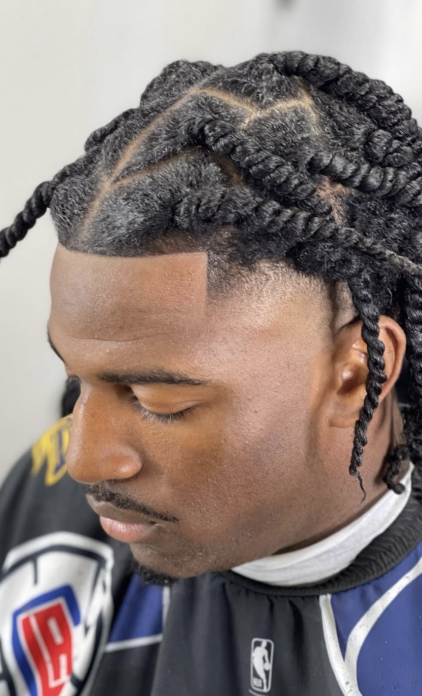 Braided twists with temple fade and part design by Sharp Society Barbershop